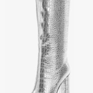 A single knee-high, silver, crocodile-textured boot with a pointed toe and a chunky block heel.
