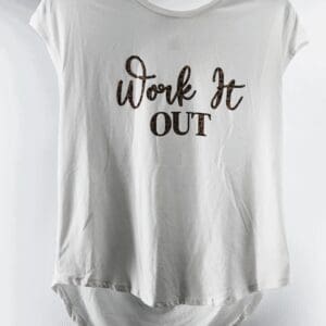 A white "Work it Out Gathered Shoulder Short Sleeve Top" in size M hangs on a hanger with "Work It OUT" printed in stylized lettering on the front.
