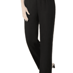 A person wearing loose-fitting black trousers and black shoes, standing with one hand resting on their hip.
