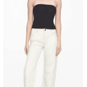 A person wearing the Black Strapless Zipper Back Top in size XL and high-waisted white jeans, standing against a plain white background.