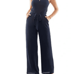 Woman modeling a navy blue sleeveless jumpsuit with wide-leg pants, a belted waist, and square neckline. She is wearing tan open-toe heels.