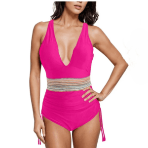 Woman wearing a bright pink one-piece swimsuit with a deep V-neckline and patterned waistband, posing against a plain background.