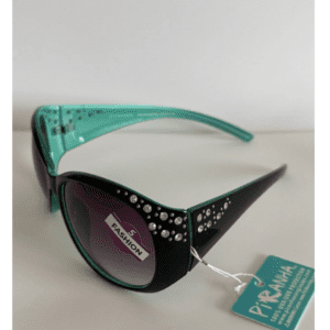 A pair of black and teal cat-eye sunglasses with rhinestone embellishments on the frames, labeled “PIRANHA” and a “5 FASHION” sticker on the lens.