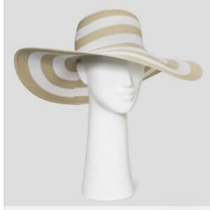 Beige and white wide-brimmed sun hat with concentric striped pattern displayed on a white mannequin head against a plain background.