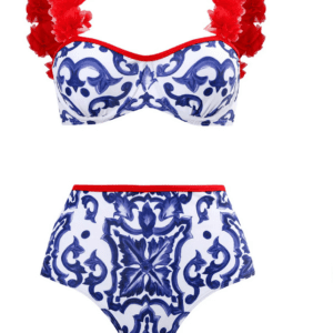 A two-piece swimsuit with a blue and white ornate pattern, red trim, and red floral appliqués on the shoulder straps of the top.