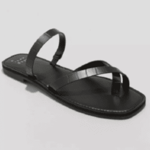Black flat sandal with three thin straps across the top, one forming an ankle loop and two crossing over the front, on a plain light background.