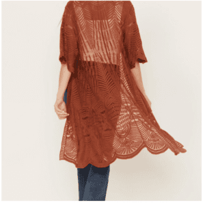 Person wearing a brown, sheer, patterned kimono-style cardigan with scalloped hem, viewed from the back, paired with blue jeans.