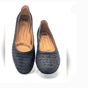 A pair of black textured flats with cushioned brown insoles, branded "Sofft," displayed on a white background.