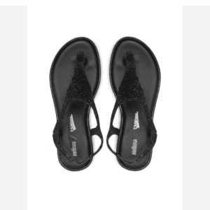 A pair of black, open-toe, flat sandals with sparkly straps is displayed on a white background, viewed from above.