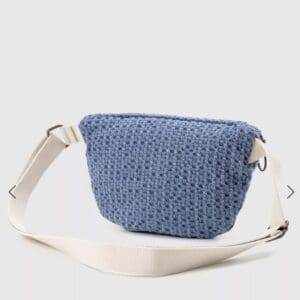 A blue woven belt bag with an adjustable beige strap.