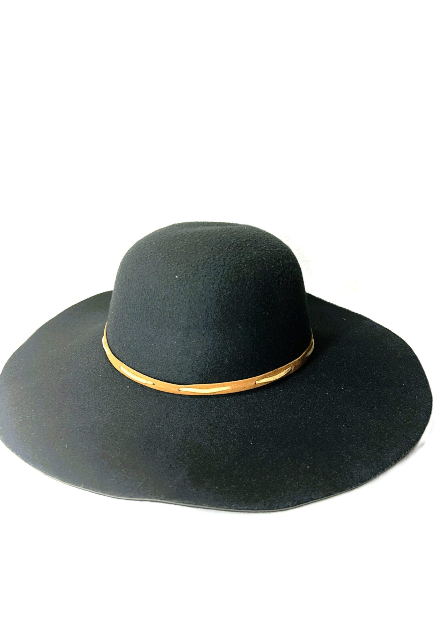 The Floppy Banded Hat is a wide-brimmed black hat featuring a thin tan band around the crown, shown on a white background.