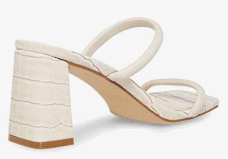 A heeled sandal with a square toe, two thin straps, and a textured block heel in an off-white color.